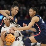 
              South Carolina's Destanni Henderson is fouled as she drives between UConn's Olivia Nelson-Ododa and Azzi Fudd during the second half of a college basketball game in the final round of the Women's Final Four NCAA tournament Sunday, April 3, 2022, in Minneapolis. (AP Photo/Eric Gay)
            