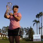 
              Nasa Hataoka holds the winner's trophy after winning the LPGA's DIO Implant LA Open golf tournament at Wilshire Country Club on Sunday, April 24, 2022, in Los Angeles. (AP Photo/Ashley Landis)
            