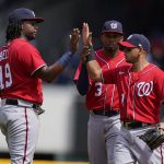 
              Washington Nationals' Josh Bell, left, Alcides Escobar, center, and Cesar Hernandez, right, high-five after defeating the Atlanta Braves in a baseball game, Wednesday, April 13, 2022, in Atlanta. (AP Photo/Brynn Anderson)
            