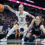 
              Stanford's Lexie Hull and UConn's Paige Bueckers go after a loose ball during the first half of a college basketball game in the semifinal round of the Women's Final Four NCAA tournament Friday, April 1, 2022, in Minneapolis. (AP Photo/Eric Gay)
            
