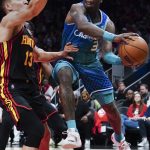 
              Charlotte Hornets guard Terry Rozier (3) moves around Atlanta Hawks defender Bogdan Bogdanovic during the second half of an NBA play-in basketball game Wednesday, April 13, 2022, in Atlanta. (AP Photo/John Bazemore)
            