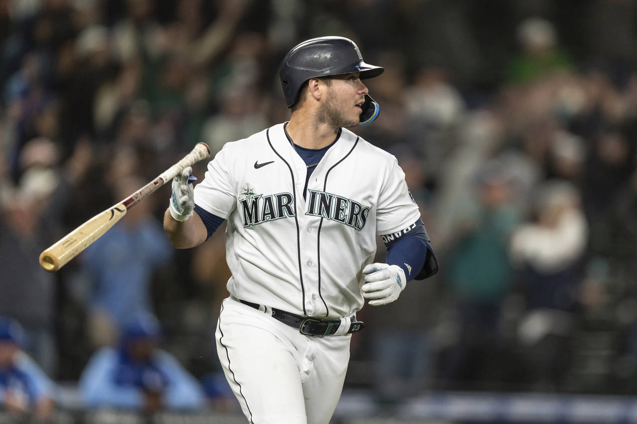 Seattle Mariners' Ty France flips his bat after hitting a three-run home run that scored Julio Rodr...