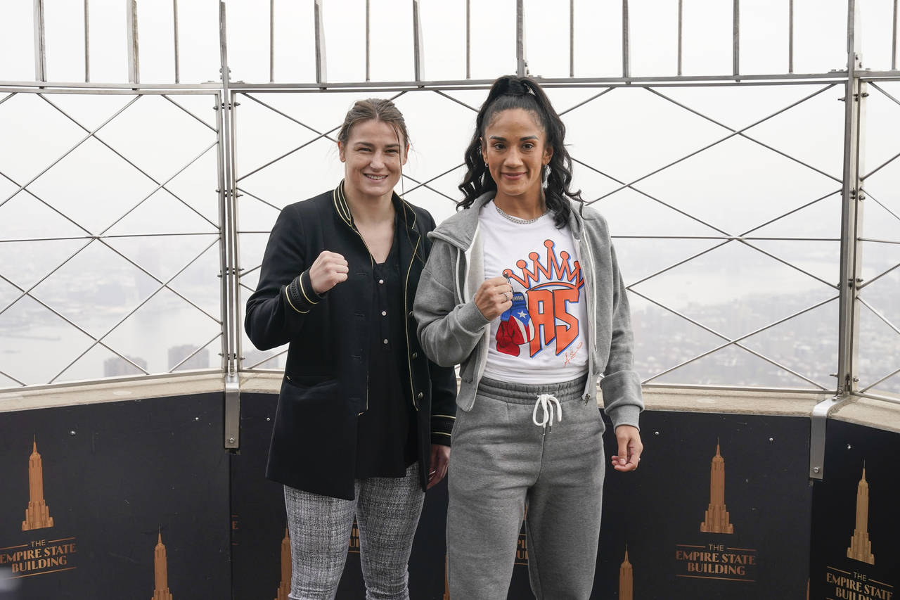 Boxers Amanda Serrano, right, and Katie Taylor pose for pictures on the observation deck of the Emp...