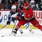 
              Carolina Hurricanes' Jordan Staal (11) controls the puck next to Winnipeg Jets' Pierre-Luc Dubois (80) during the first period of an NHL hockey game in Raleigh, N.C., Thursday, April 21, 2022. (AP Photo/Karl B DeBlaker)
            