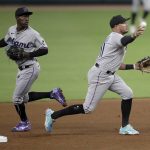 
              Miami Marlins' Miguel Rojas, right, throws to first base to complete a double play against the Atlanta Braves in the fourth inning of a baseball game Friday, April 22, 2022, in Atlanta. Backing up the play is Jazz Chisholm Jr., left. Orlando Arcia was out at second, and Guillermo Heredia at first. (AP Photo/Ben Margot)
            