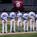 
              The New York Mets wear the number 42 in honor of Jackie Robinson as the national anthem is played before a baseball game against the Arizona Diamondbacks, Friday, April 15, 2022, in New York. (AP Photo/John Minchillo)
            