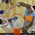 
              North Carolina forward Armando Bacot, left, and Kansas forward Mitch Lightfoot, right, vie for a rebound during the first half of a college basketball game in the finals of the Men's Final Four NCAA tournament, Monday, April 4, 2022, in New Orleans. (AP Photo/Brynn Anderson)
            