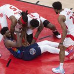 
              Philadelphia 76ers' Joel Embiid (21) wrestles for a loose ball with Toronto Raptors' Precious Achiuwa (5) and OG Anunoby (3) as Raptors forward Thaddeus Young looks on during the second half of Game 4 of an NBA basketball first-round playoff series, Saturday, April 23, 2022 in Toronto. (Chris Young/The Canadian Press via AP)
            