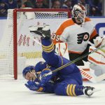 
              Buffalo Sabres right wing Kyle Okposo (21) falls to the ice injured during the first period of an NHL hockey game against the Philadelphia Flyers on Saturday, April. 16, 2022, in Buffalo, N.Y. (AP Photo/Joshua Bessex)
            