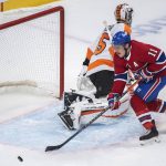 
              Philadelphia Flyers goaltender Martin Jones loses track of the puck as Montreal Canadiens' Brendan Gallagher goes for the rebound during the first period of an NHL hockey game Thursday, April 21, 2022, in Montreal. (Graham Hughes/The Canadian Press via AP)
            