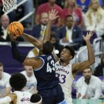 
              Villanova forward Eric Dixon (43) heads to the hoop against Kansas forward David McCormack (33) during the first half of a college basketball game in the semifinal round of the Men's Final Four NCAA tournament, Saturday, April 2, 2022, in New Orleans. (AP Photo/Gerald Herbert)
            