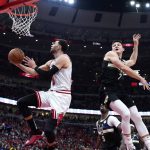 
              Chicago Bulls guard Zach LaVine, left, drives to the basket past Milwaukee Bucks guard Grayson Allen during the first half of Game 4 of a first-round NBA basketball playoff series, Sunday, April 24, 2022, in Chicago. (AP Photo/Nam Y. Huh)
            
