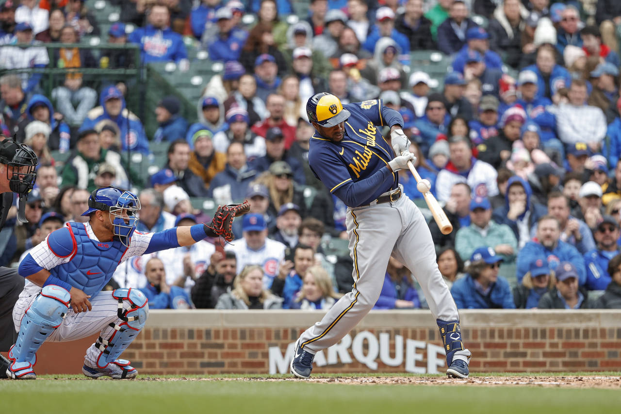 Milwaukee Brewers' Lorenzo Cain hits an RBI-ground out against the Chicago Cubs during the fourth i...