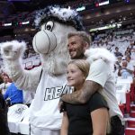
              David Beckham and his daughter Harper Seven Beckham pose for a photo with the Miami Heat mascot Burnie during the first half of Game 2 of an NBA basketball first-round playoff series between the Miami Heat and Atlanta Hawks, Tuesday, April 19, 2022, in Miami. (AP Photo/Lynne Sladky)
            