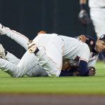 
              Houston Astros second baseman Niko Goodrum, left, falls to ground with shortstop Jeremy Pena while catching a sacrifice fly ball by Toronto Blue Jays' Lourdes Gurriel Jr. during the sixth inning of a baseball game Saturday, April 23, 2022, in Houston. (AP Photo/David J. Phillip)
            