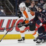 
              Philadelphia Flyers' Joel Farabee, left, carries the puck up ice past Columbus Blue Jackets' Zach Werenski during the first period of an NHL hockey game Thursday, April 7, 2022, in Columbus, Ohio. (AP Photo/Jay LaPrete)
            