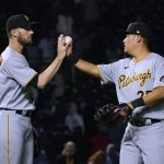 
              Pittsburgh Pirates relief pitcher Chris Stratton, left, and first baseman Yoshi Tsutsugo celebrate the team's 4-3 win over the Chicago Cubs after a baseball game Thursday, April 21, 2022, in Chicago. (AP Photo/Charles Rex Arbogast)
            