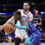 
              Charlotte Hornets guard Terry Rozier, front, drives to the basket against Chicago Bulls guard Zach LaVine during the first half of an NBA basketball game in Chicago, Friday, April 8, 2022. (AP Photo/Nam Y. Huh)
            