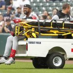 
              Chicago White Sox's Eloy Jimenez leaves the field on a cart after falling to the turf on a groundout to the Minnesota Twins in the second inning of a baseball game Saturday, April 23, 2022, in Minneapolis. (AP Photo/Bruce Kluckhohn)
            