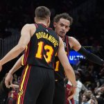 
              Atlanta Hawks guards Trae Young and Bogdan Bogdanovic (13) celebrate after a Hawks basket during the second half of the team's NBA play-in basketball game against the Charlotte Hornets on Wednesday, April 13, 2022, in Atlanta. (AP Photo/John Bazemore)
            