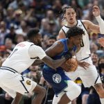 
              Minnesota Timberwolves forward Anthony Edwards, center, drives to the basket between Denver Nuggets forwards JaMychal Green, left, and Aaron Gordon in the second half of an NBA basketball game Friday, April 1, 2022, in Denver. (AP Photo/David Zalubowski)
            