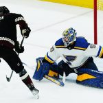 
              St. Louis Blues goaltender Jordan Binnington (50) makes a save on a shot by Arizona Coyotes left wing Loui Eriksson (21) during the first period of an NHL hockey game Saturday, April 23, 2022, in Glendale, Ariz. (AP Photo/Ross D. Franklin)
            