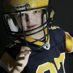 
              In a photo provided by Melissa Hutchinson, Aidan Hutchinson wears a Michigan football helmet, date and location not known. Jacksonville is expected to select Hutchinson with the No. 1 pick in the NFL draft on Thursday night, April 28. It's easy to see why the Jaguars would want him after watching what Hutchinson did last year at Michigan. Scouts who searched for more about his background found out Chris and Melissa raised a well-rounded son, uniquely shaped by a close-knit family that includes two older sisters. (Melissa Hutchinson via AP)
            