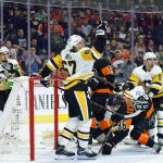 
              Pittsburgh Penguins' Rickard Rakell, center, reaches up for the puck during the second period of an NHL hockey game against the Philadelphia Flyers, Sunday, April 24, 2022, in Philadelphia. (AP Photo/Chris Szagola)
            