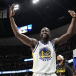 
              Golden State Warriors forward Draymond Green gestures to fans as they heckle him after he fouled out late in the second half of Game 4 of an NBA basketball first-round Western Conference playoff series against the Denver Nuggets, Sunday, April 24, 2022, in Denver. (AP Photo/David Zalubowski)
            