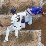 
              Chicago Cubs' Patrick Wisdom slides safely home past Milwaukee Brewers' Jandel Gustave during the seventh inning of a baseball game Friday, April 29, 2022, in Milwaukee. Wisdom scored on a wild pitch. (AP Photo/Morry Gash)
            