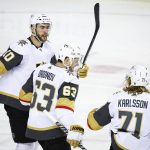 
              Vegas Golden Knights' Evgenii Dadonov, center, celebrates his goal with teammates Nicolas Roy, left, and William Karlsson during second-period NHL hockey game action against the Calgary Flames in Calgary, Alberta, Thursday, April 14, 2022. (Jeff McIntosh/The Canadian Press via AP)
            