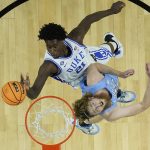 
              Duke's AJ Griffin (21) shoots over North Carolina's Brady Manek during the first half of a college basketball game in the semifinal round of the Men's Final Four NCAA tournament, Saturday, April 2, 2022, in New Orleans. (AP Photo/David J. Phillip)
            