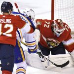 
              Florida Panthers goaltender Sergei Bobrovsky (72) makes a save as Buffalo Sabres right wing Kyle Okposo (21) is checked by Panthers defenseman Gustav Forsling (42) during the first period of an NHL hockey game Friday, April 8, 2022, in Sunrise, Fla. (AP Photo/Jim Rassol)
            