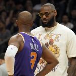 
              Los Angeles Lakers forward LeBron James talks with Phoenix Suns guard Chris Paul (3) during the first half of an NBA basketball game Tuesday, April 5, 2022, in Phoenix. (AP Photo/Rick Scuteri)
            