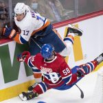 
              New York Islanders' Matt Martin (17) upends Montreal Canadiens' David Savard during second-period NHL hockey game action in Montreal, Friday, April 15, 2022. (Graham Hughes/The Canadian Press via AP)
            