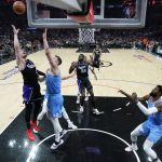 
              Sacramento Kings guard Donte DiVincenzo, left, shoots over Los Angeles Clippers center Isaiah Hartenstein during the first half of an NBA basketball game Saturday, April 9, 2022, in Los Angeles. (AP Photo/Marcio Jose Sanchez)
            