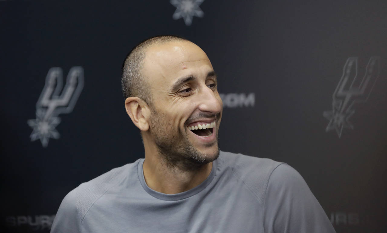 FILE - Former San Antonio Spurs guard Manu Ginobili jokes with the media at the NBA basketball team...
