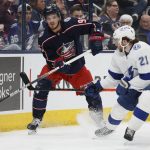 
              Columbus Blue Jackets' Jack Roslovic, left, passes the puck around the net as Tampa Bay Lightning's Brayden Point defends during the second period of an NHL hockey game Thursday, April 28, 2022, in Columbus, Ohio. (AP Photo/Jay LaPrete)
            