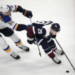 
              St. Louis Blues defenseman Colton Parayko, left, pursues Colorado Avalanche center Nathan MacKinnon as he collects the puck in the first period of an NHL hockey game Tuesday, April 26, 2022, in Denver. (AP Photo/David Zalubowski)
            