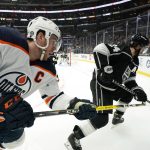 
              Edmonton Oilers center Connor McDavid, left, and Los Angeles Kings center Phillip Danault goes after the puck during the third period of an NHL hockey game Thursday, April 7, 2022, in Los Angeles. (AP Photo/Mark J. Terrill)
            