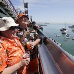 
              San Francisco Giants fans Jane Gire, left, and Lincoln Rogala look out toward McCovey Cove outside of Oracle Park before a baseball game between the Giants and the Miami Marlins in San Francisco, Friday, April 8, 2022. (AP Photo/Eric Risberg)
            