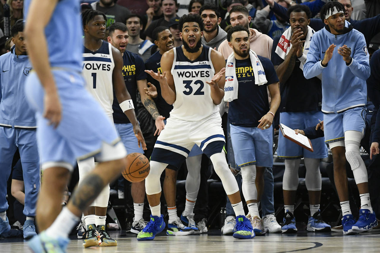 Minnesota Timberwolves center Karl-Anthony Towns reacts after an official called him for out of bou...