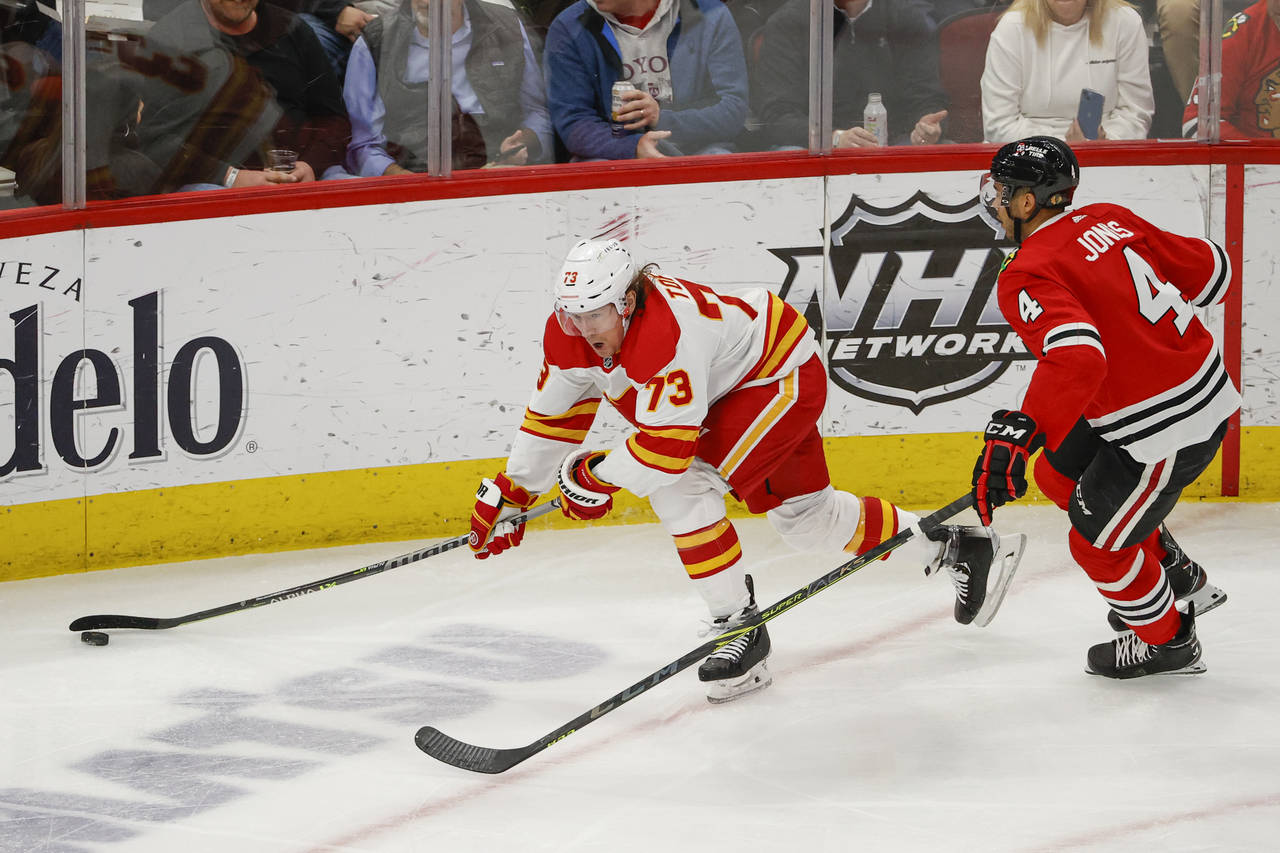 Calgary Flames right wing Tyler Toffoli (73) looks to pass the puck against Chicago Blackhawks defe...