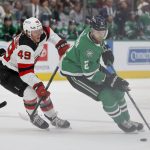 
              Dallas Stars defenseman Jani Hakanpaa (2) moves the puck past New Jersey Devils left wing Fabian Zetterlund (49) during the first period of an NHL hockey game in Dallas, Saturday, April 9, 2022. (AP Photo/Michael Ainsworth)
            
