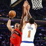 
              Toronto Raptors forward Scottie Barnes (4) shoots against New York Knicks forward Obi Toppin (1) during the first half of an NBA basketball game, Sunday, April 10, 2022 in New York. (AP Photo/Jessie Alcheh)
            