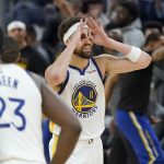 
              Golden State Warriors guard Klay Thompson (11) gestures after teammate Stephen Curry's 3-point basket during the first half of Game 2 of an NBA basketball first-round playoff series against the Denver Nuggets in San Francisco, Monday, April 18, 2022. (AP Photo/Jeff Chiu)
            