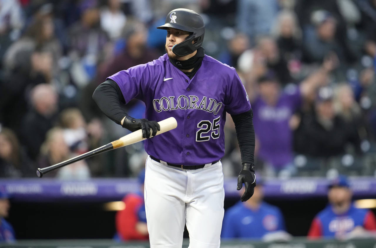 Colorado Rockies' C.J. Cron tosses his bat after hitting a two-run home run off Chicago Cubs starti...