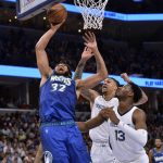 
              Minnesota Timberwolves center Karl-Anthony Towns (32) next to Memphis Grizzlies forward Jaren Jackson Jr. (13) and center Brandon Clarke during the second half during Game 1 of a first-round NBA basketball playoff series Saturday, April 16, 2022, in Memphis, Tenn. (AP Photo/Brandon Dill)
            