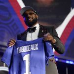 
              Oregon defensive end Kayvon Thibodeaux holds a jersey after being picked by the New York Giants with the fifth pick of the NFL football draft Thursday, April 28, 2022, in Las Vegas. (AP Photo/John Locher )
            
