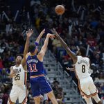 
              Golden State Warriors guard Klay Thompson (11) shoots between New Orleans Pelicans guard Trey Murphy III (25) and forward Naji Marshall (8) in the second half of an NBA basketball game in New Orleans, Sunday, April 10, 2022. The Warriors won 128-107. (AP Photo/Gerald Herbert)
            